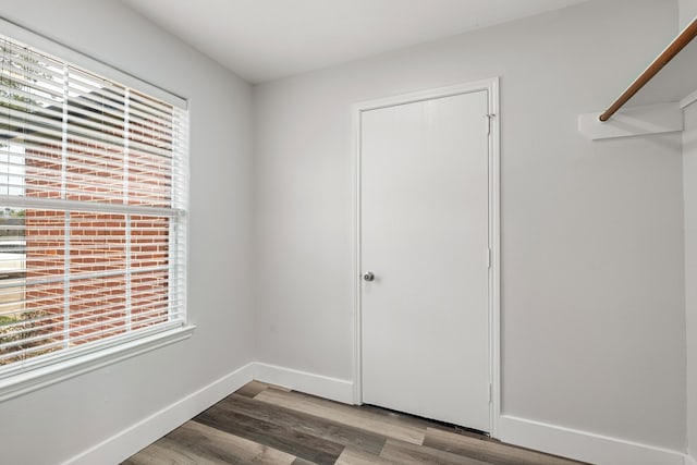 21606 Borah Peak Way, Katy, TX 77449 - unfurnished bedroom with multiple windows, wood finished floors, baseboards, and a closet