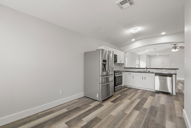 21606 Borah Peak Way, Katy, TX 77449 - kitchen featuring appliances with stainless steel finishes, a peninsula, recessed lighting, a ceiling fan, and a sink