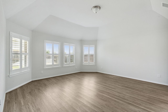 19218 Charisma Rose Ln, Tomball, TX 77377 - spare room with lofted ceiling, healthy amount of natural light, wood finished floors, and baseboards