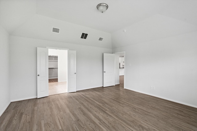 19218 Charisma Rose Ln, Tomball, TX 77377 - unfurnished bedroom with dark wood-style floors, baseboards, a spacious closet, high vaulted ceiling, and a closet