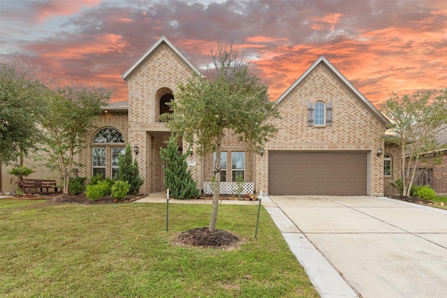 14907 Somerset Horizon Ln, Houston, TX 77044 - traditional home with concrete driveway, a front lawn, brick siding, and an attached garage