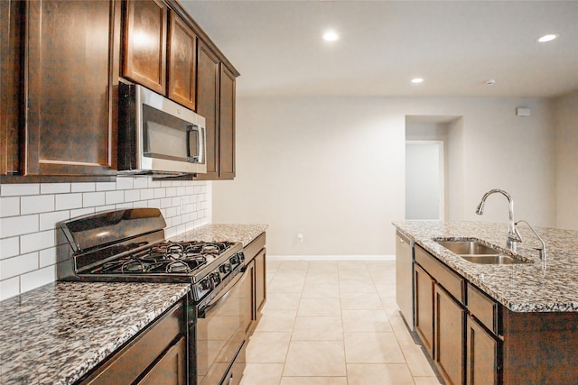 3518 Windham Way, Katy, TX 77494 - kitchen featuring appliances with stainless steel finishes, a sink, backsplash, stone countertops, and recessed lighting