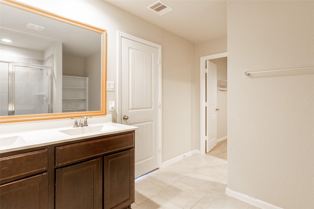 3518 Windham Way, Katy, TX 77494 - bathroom featuring a walk in closet, a shower stall, double vanity, tile patterned floors, and baseboards