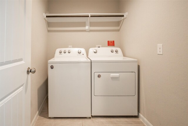 3518 Windham Way, Katy, TX 77494 - laundry room featuring washing machine and clothes dryer, light tile patterned floors, and baseboards