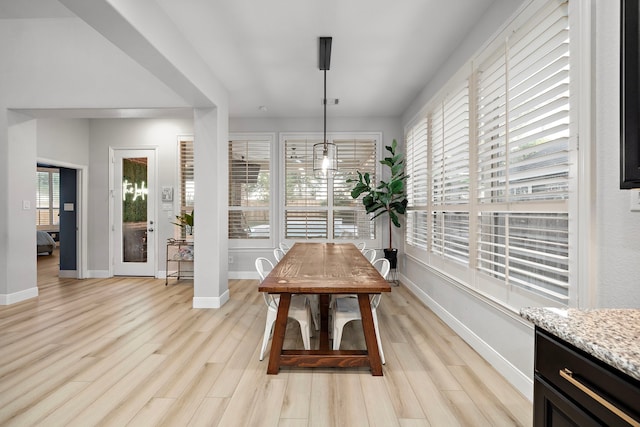 8442 Horsepen Bend Dr, Conroe, TX 77385 - dining area featuring baseboards and light wood-style flooring