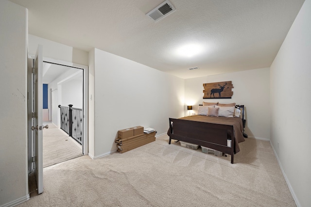 8442 Horsepen Bend Dr, Conroe, TX 77385 - carpeted bedroom with baseboards and a textured ceiling