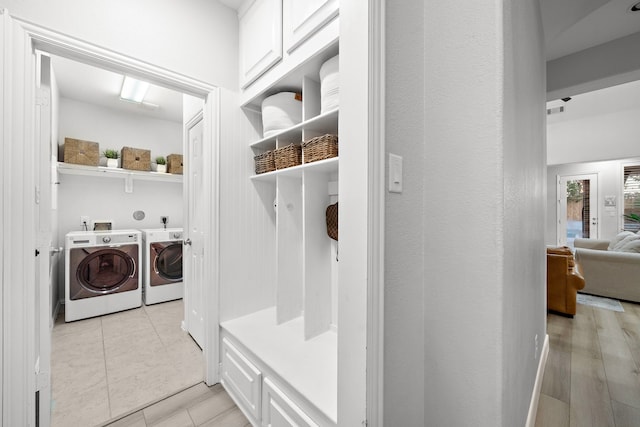 8442 Horsepen Bend Dr, Conroe, TX 77385 - mudroom featuring washing machine and clothes dryer and light tile patterned floors