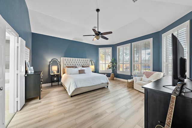 8442 Horsepen Bend Dr, Conroe, TX 77385 - bedroom featuring light wood-style floors, multiple windows, baseboards, a ceiling fan, and lofted ceiling