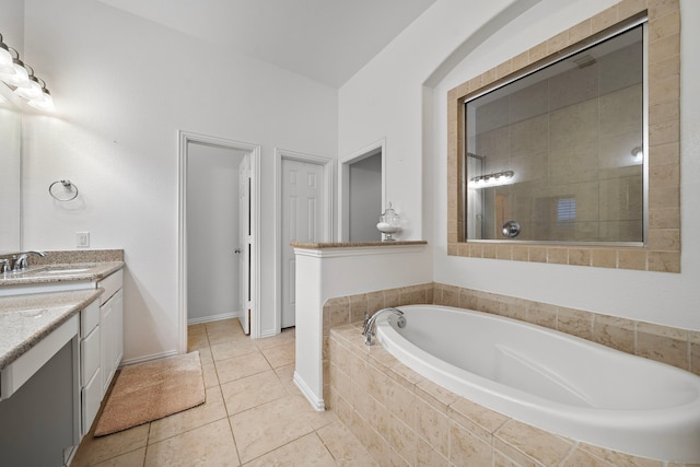 8442 Horsepen Bend Dr, Conroe, TX 77385 - bathroom featuring vanity, a garden tub, tile patterned flooring, and baseboards