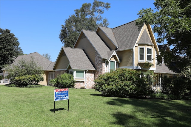 3003 Roseheath Ln, Houston, TX 77073 - view of front of home featuring a front lawn, a shingled roof, and brick siding