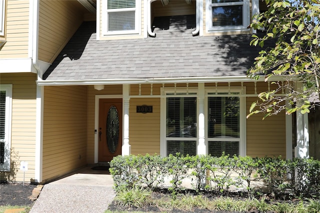 3003 Roseheath Ln, Houston, TX 77073 - view of exterior entry featuring a shingled roof and a porch