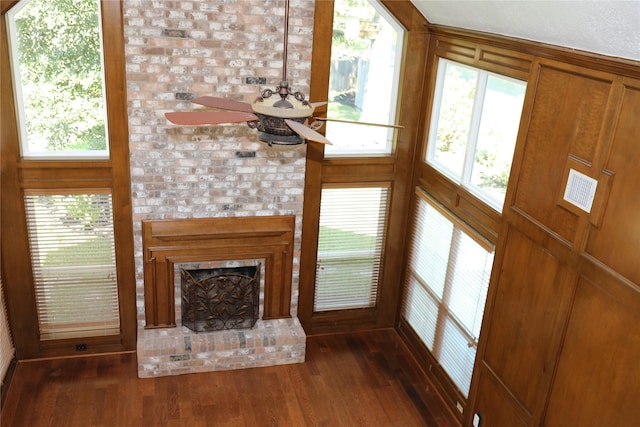 3003 Roseheath Ln, Houston, TX 77073 - unfurnished living room with dark wood-style floors, a ceiling fan, and a fireplace