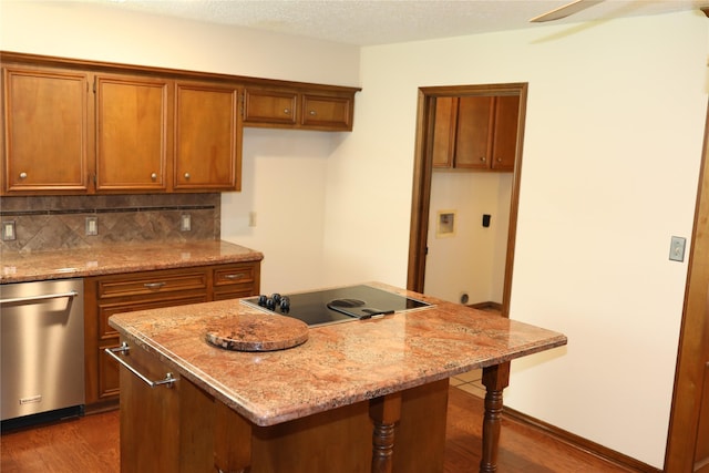3003 Roseheath Ln, Houston, TX 77073 - kitchen with brown cabinets, black electric cooktop, dark wood-type flooring, and a center island
