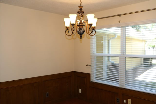 3003 Roseheath Ln, Houston, TX 77073 - spare room with a chandelier and wainscoting