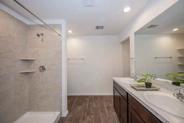 5126 Ternberry Forest Ln, Katy, TX 77449 - bathroom with wood finished floors, double vanity, a tile shower, recessed lighting, and baseboards