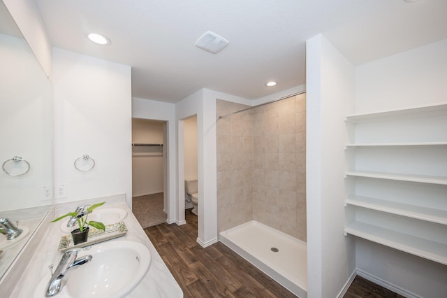 5126 Ternberry Forest Ln, Katy, TX 77449 - bathroom featuring toilet, wood finished floors, a tile shower, double vanity, and recessed lighting