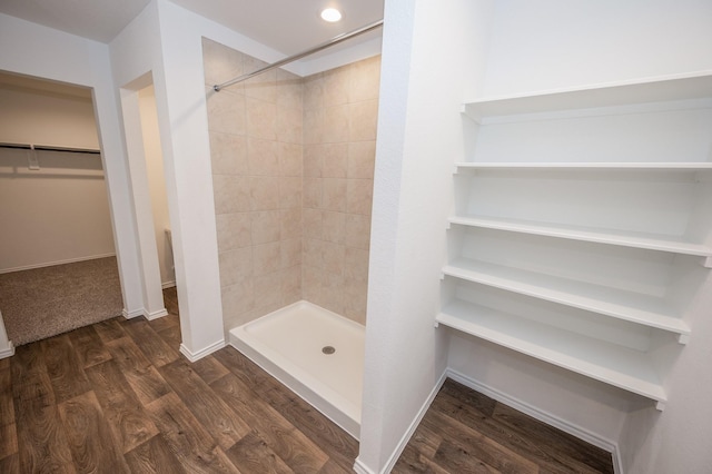 5126 Ternberry Forest Ln, Katy, TX 77449 - bathroom with a tile shower, a spacious closet, wood finished floors, and baseboards
