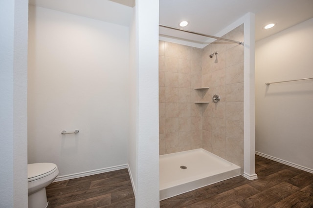 5126 Ternberry Forest Ln, Katy, TX 77449 - bathroom with toilet, a tile shower, wood finished floors, baseboards, and recessed lighting