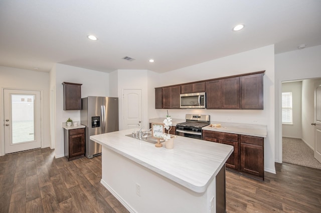 5126 Ternberry Forest Ln, Katy, TX 77449 - kitchen featuring stainless steel appliances, dark brown cabinetry, dark wood-style flooring, light countertops, and recessed lighting
