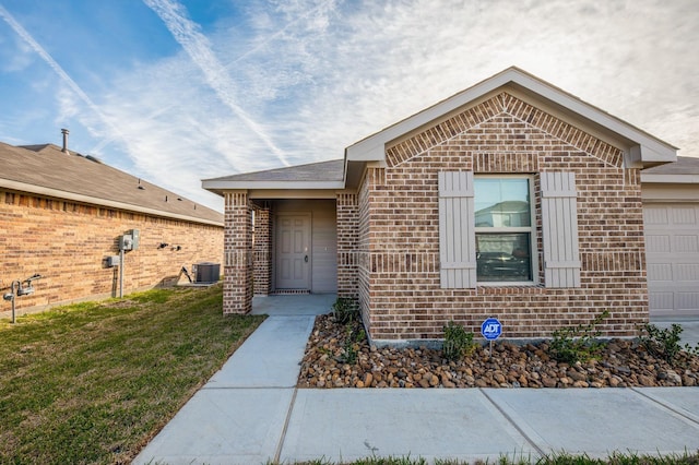 5126 Ternberry Forest Ln, Katy, TX 77449 - view of exterior entry featuring brick siding, an attached garage, a yard, and central air condition unit