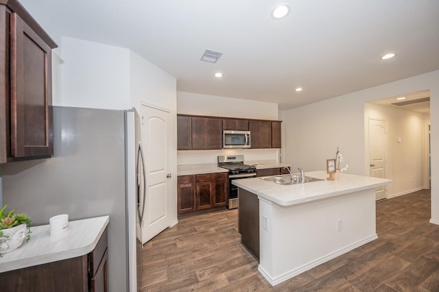 5126 Ternberry Forest Ln, Katy, TX 77449 - kitchen with stainless steel appliances, a sink, dark wood-style floors, dark brown cabinetry, and recessed lighting