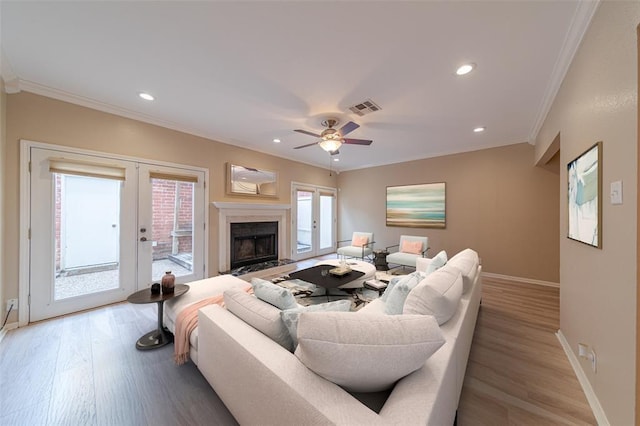 2444 Bering Dr Unit 2444, Houston, TX 77057 - living area featuring ornamental molding, baseboards, french doors, light wood-style floors, and healthy amount of natural light