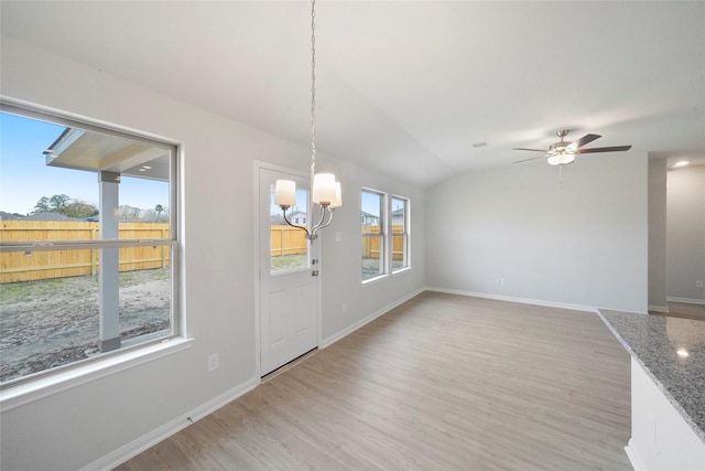 805 Clear Valley Ln, Dayton, TX 77535 - unfurnished dining area featuring a chandelier, light wood-style flooring, ceiling fan, baseboards, and vaulted ceiling