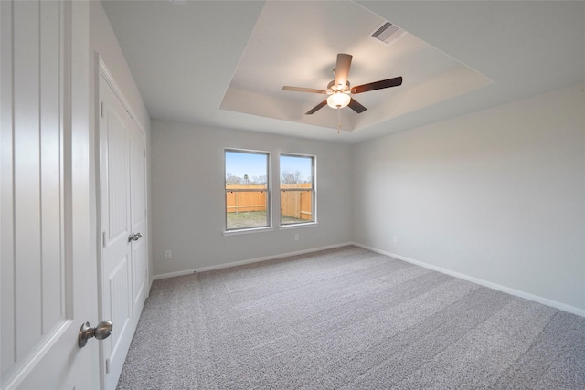 805 Clear Valley Ln, Dayton, TX 77535 - unfurnished bedroom featuring carpet, baseboards, a tray ceiling, and a ceiling fan