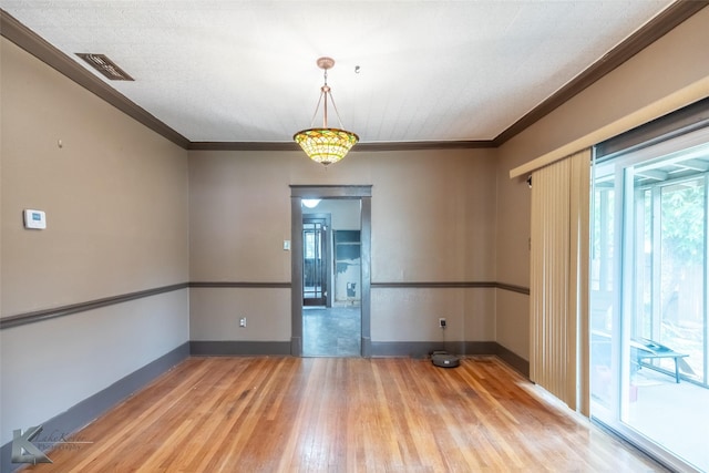 1166 Ross Ave, Abilene, TX 79605 - spare room with light wood-style flooring, baseboards, and crown molding