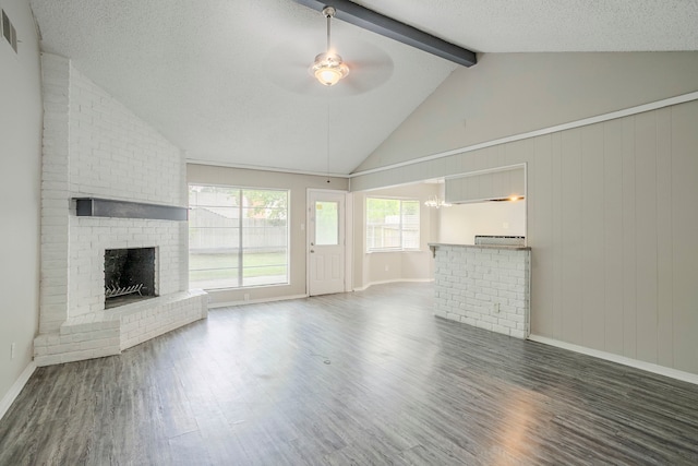 5606 Cypressgate Dr, Spring, TX 77373 - unfurnished living room with ceiling fan, a brick fireplace, wood finished floors, baseboards, and a chandelier