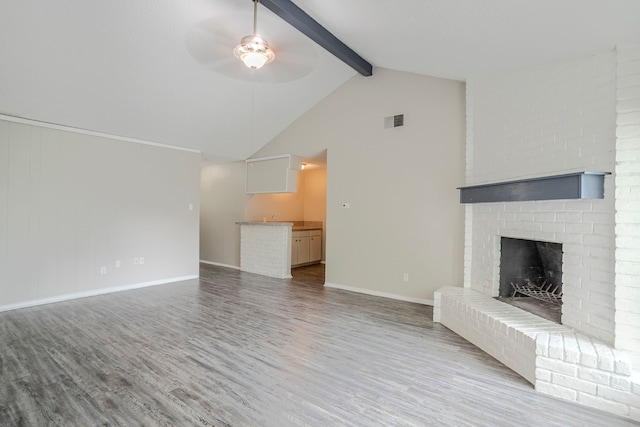 5606 Cypressgate Dr, Spring, TX 77373 - unfurnished living room with wood finished floors, a ceiling fan, beamed ceiling, baseboards, and a fireplace