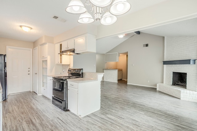 5606 Cypressgate Dr, Spring, TX 77373 - kitchen with black range with electric stovetop, open floor plan, light wood-style flooring, and white cabinetry