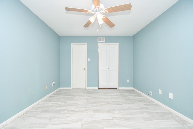 2350 Bering Dr Unit 105, Houston, TX 77057 - unfurnished bedroom featuring light marble finish floors, baseboards, ceiling fan, and a closet