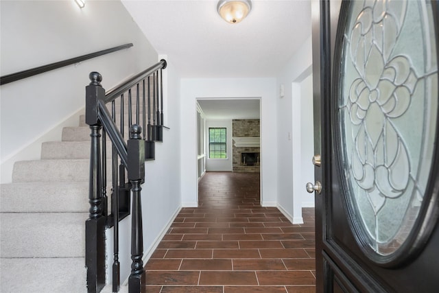 1003 Romaine Ln, Houston, TX 77090 - foyer entrance with baseboards, stairway, and a large fireplace
