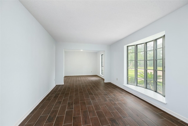 1003 Romaine Ln, Houston, TX 77090 - spare room with baseboards and dark wood-style floors