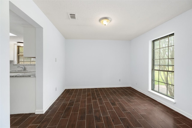 1003 Romaine Ln, Houston, TX 77090 - spare room featuring baseboards and wood finished floors