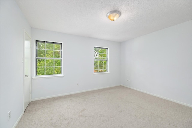 1003 Romaine Ln, Houston, TX 77090 - unfurnished room with carpet, baseboards, and a textured ceiling