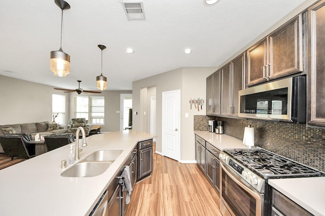 22619 Bellwick Ridge Ln, Katy, TX 77449 - kitchen featuring appliances with stainless steel finishes, a sink, light wood-type flooring, light countertops, and recessed lighting