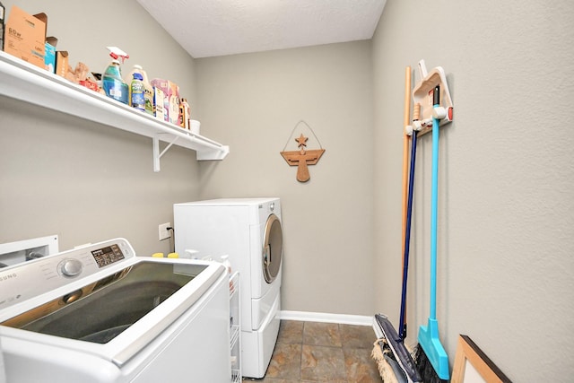22619 Bellwick Ridge Ln, Katy, TX 77449 - laundry room with washer and dryer, baseboards, and dark stone finish floors