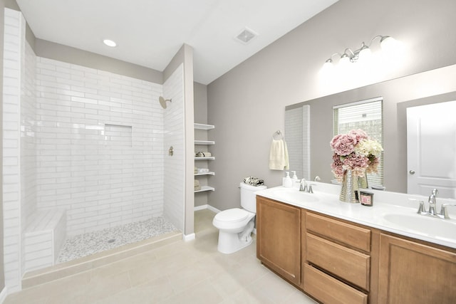 22619 Bellwick Ridge Ln, Katy, TX 77449 - bathroom featuring double vanity, toilet, a tile shower, and tile patterned flooring