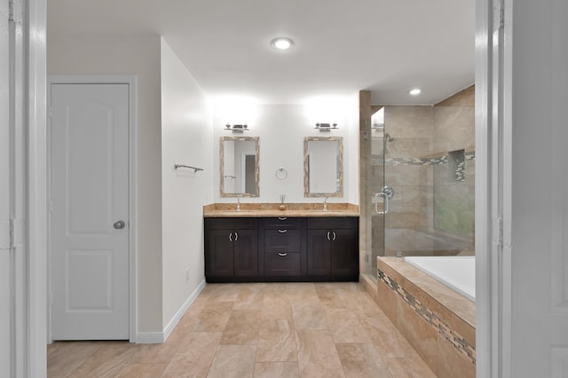 2457 Pebblebrook Cir, Conroe, TX 77384 - full bath with a stall shower, double vanity, a bath, recessed lighting, and baseboards