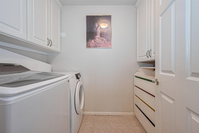 14202 Valley Bend Ct, Sugar Land, TX 77498 - laundry room with washer and dryer, cabinet space, light tile patterned flooring, and baseboards