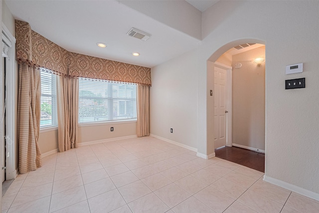 14202 Valley Bend Ct, Sugar Land, TX 77498 - unfurnished room with arched walkways, light tile patterned floors, recessed lighting, and baseboards