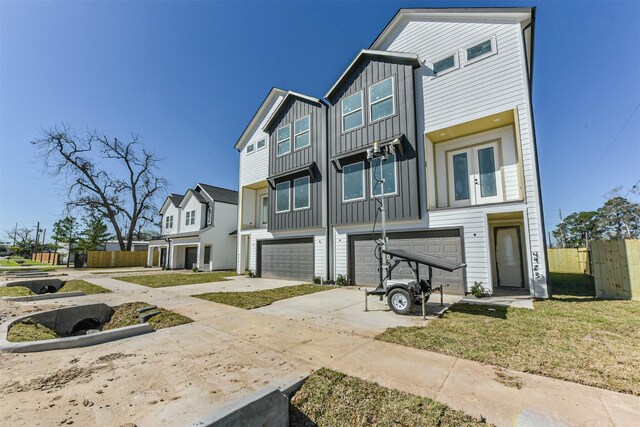 5013 Hardway St, Houston, TX 77092 - townhome / multi-family property with board and batten siding, a garage, and driveway