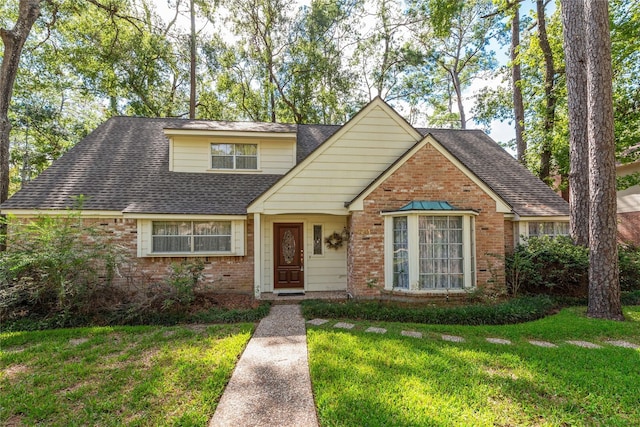 6211 Darby Way, Spring, TX 77389 - traditional home with brick siding, a front lawn, and roof with shingles