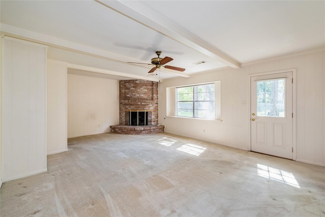 6211 Darby Way, Spring, TX 77389 - unfurnished living room with a ceiling fan, beam ceiling, a brick fireplace, carpet flooring, and a decorative wall