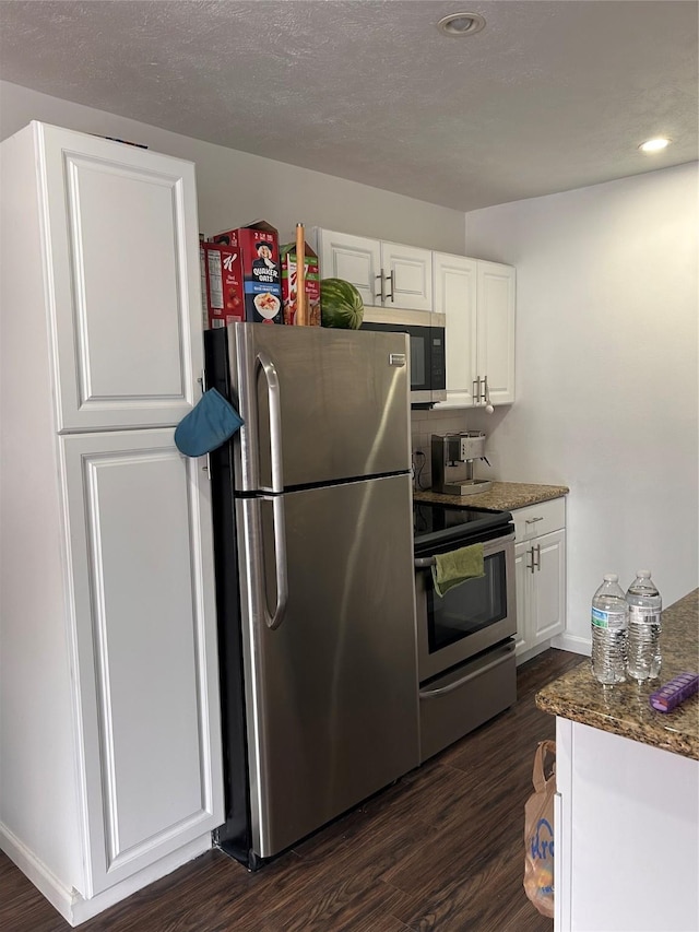 3400 Timmons Ln Unit 30, Houston, TX 77027 - kitchen with stainless steel appliances, dark wood-type flooring, white cabinets, recessed lighting, and baseboards