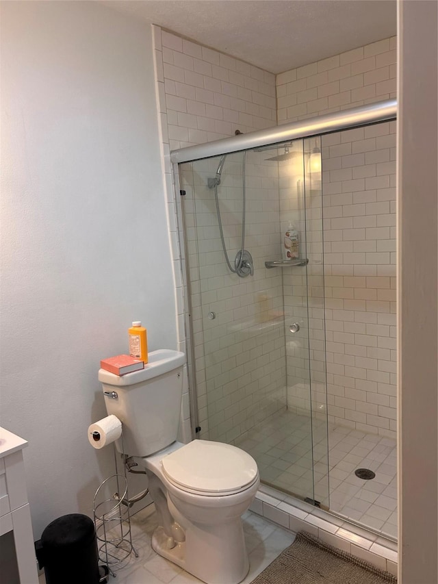 3400 Timmons Ln Unit 30, Houston, TX 77027 - full bathroom with toilet, a stall shower, vanity, and tile patterned floors