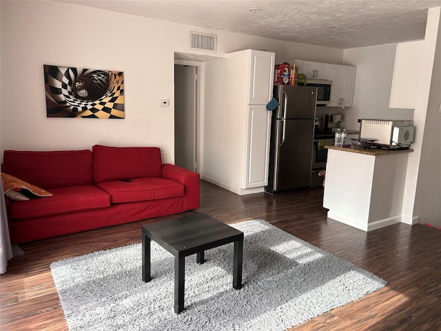 3400 Timmons Ln Unit 30, Houston, TX 77027 - living area featuring wood finished floors, baseboards, and a textured ceiling