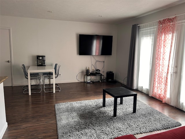 3400 Timmons Ln Unit 30, Houston, TX 77027 - living area featuring plenty of natural light, baseboards, and wood finished floors